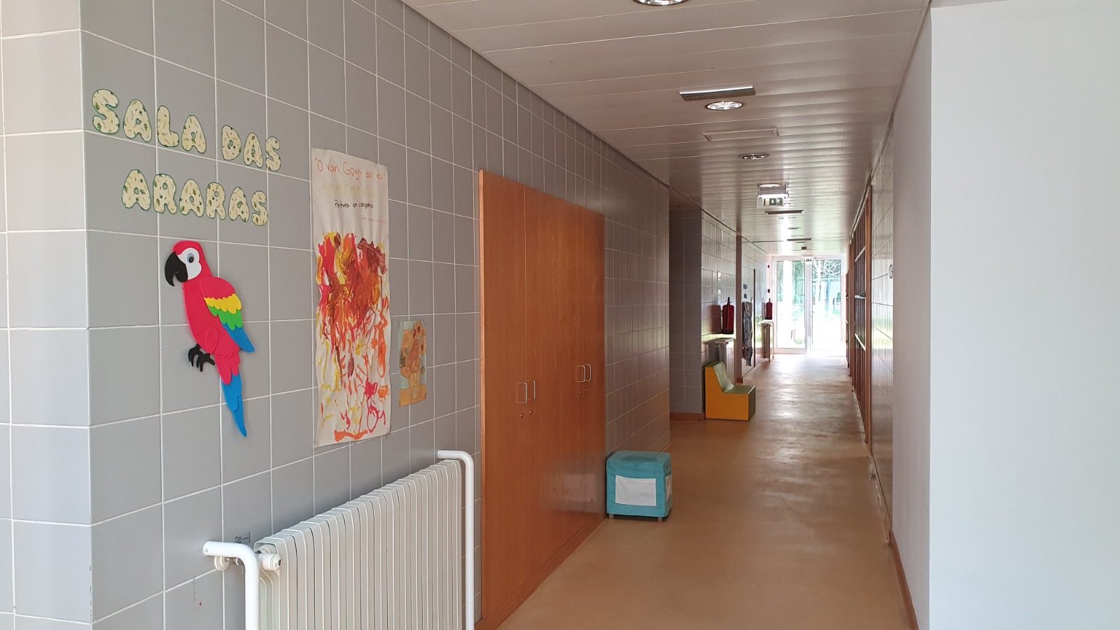 School hallway with children's artwork and a parrot decoration