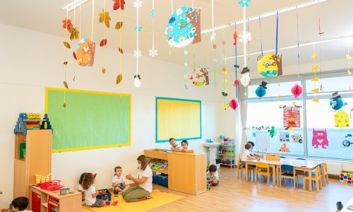 Preschool classroom with children engaged in play and learning activities