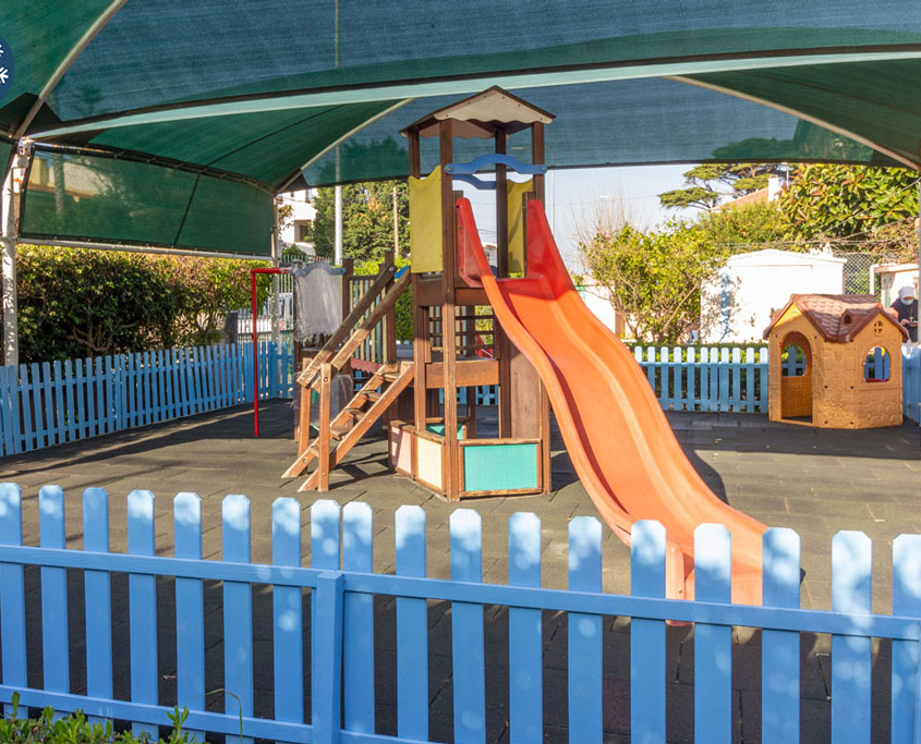 Preschool playground with slide and playhouse