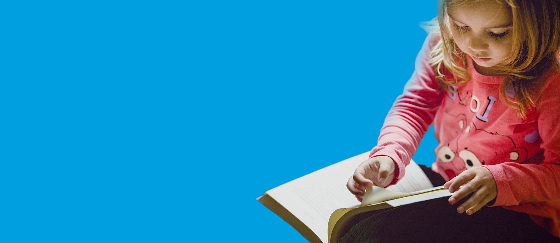 Preschool child reading a book