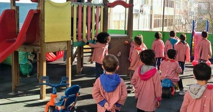 Preschool children playing on playground equipment