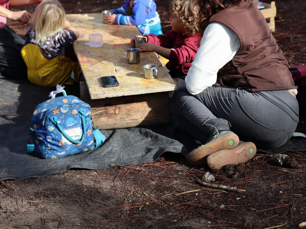 Preschool children enjoying a snack outdoors