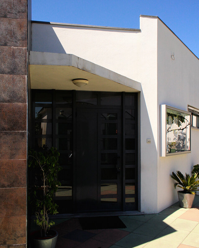 Exterior view of A Nossa Creche preschool, showcasing the building's modern architecture and entrance.