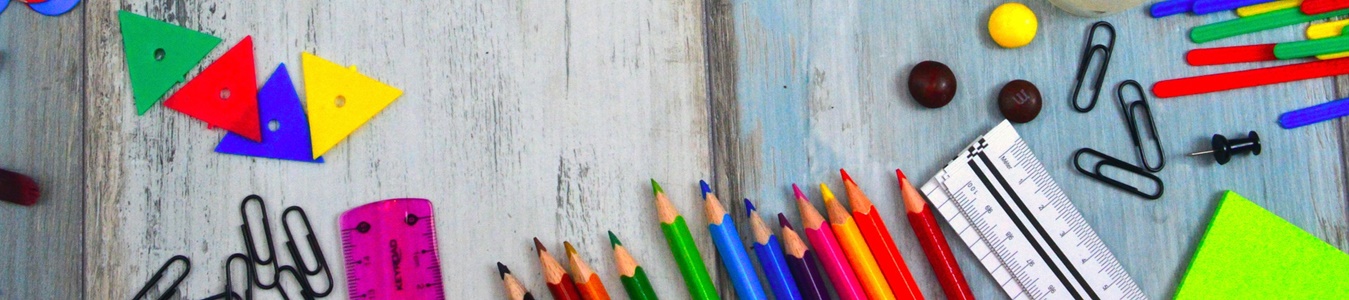 Colorful school supplies on a wooden surface