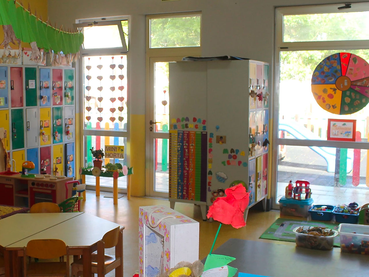 Preschool classroom with colorful cabinets, toys, and educational materials
