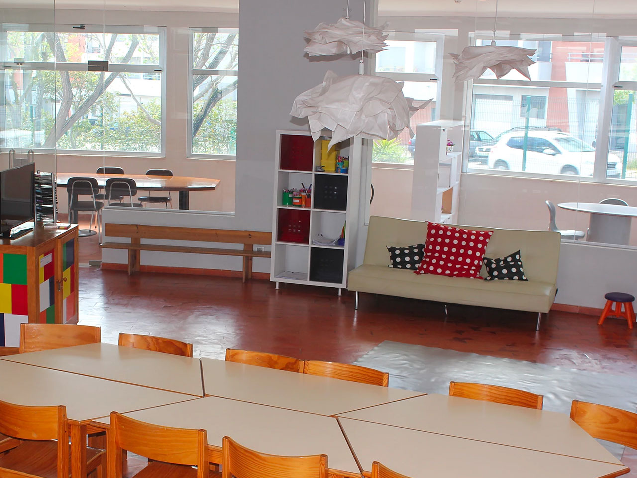 Preschool classroom with tables, chairs, and a couch