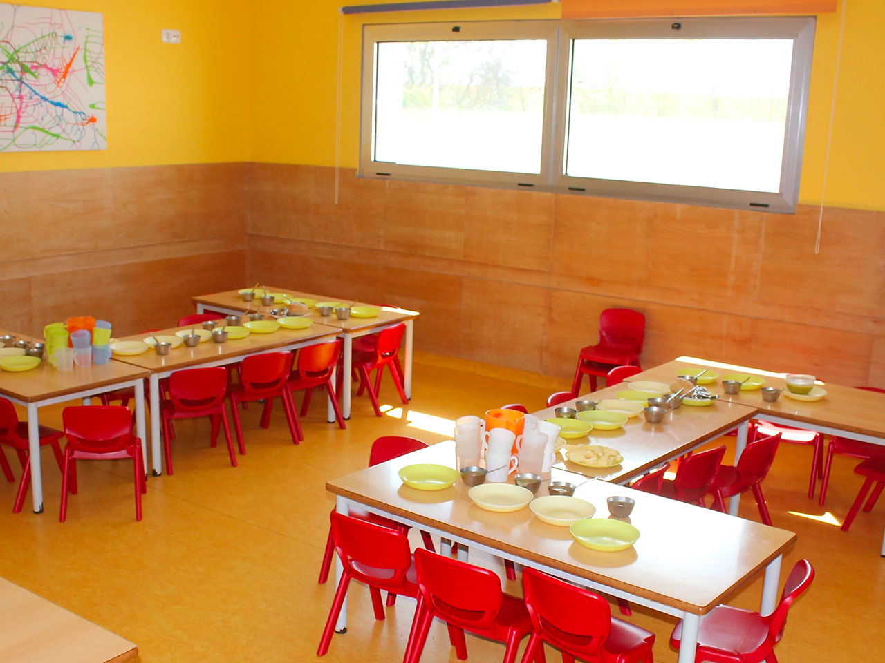 Preschool dining room with small tables and chairs