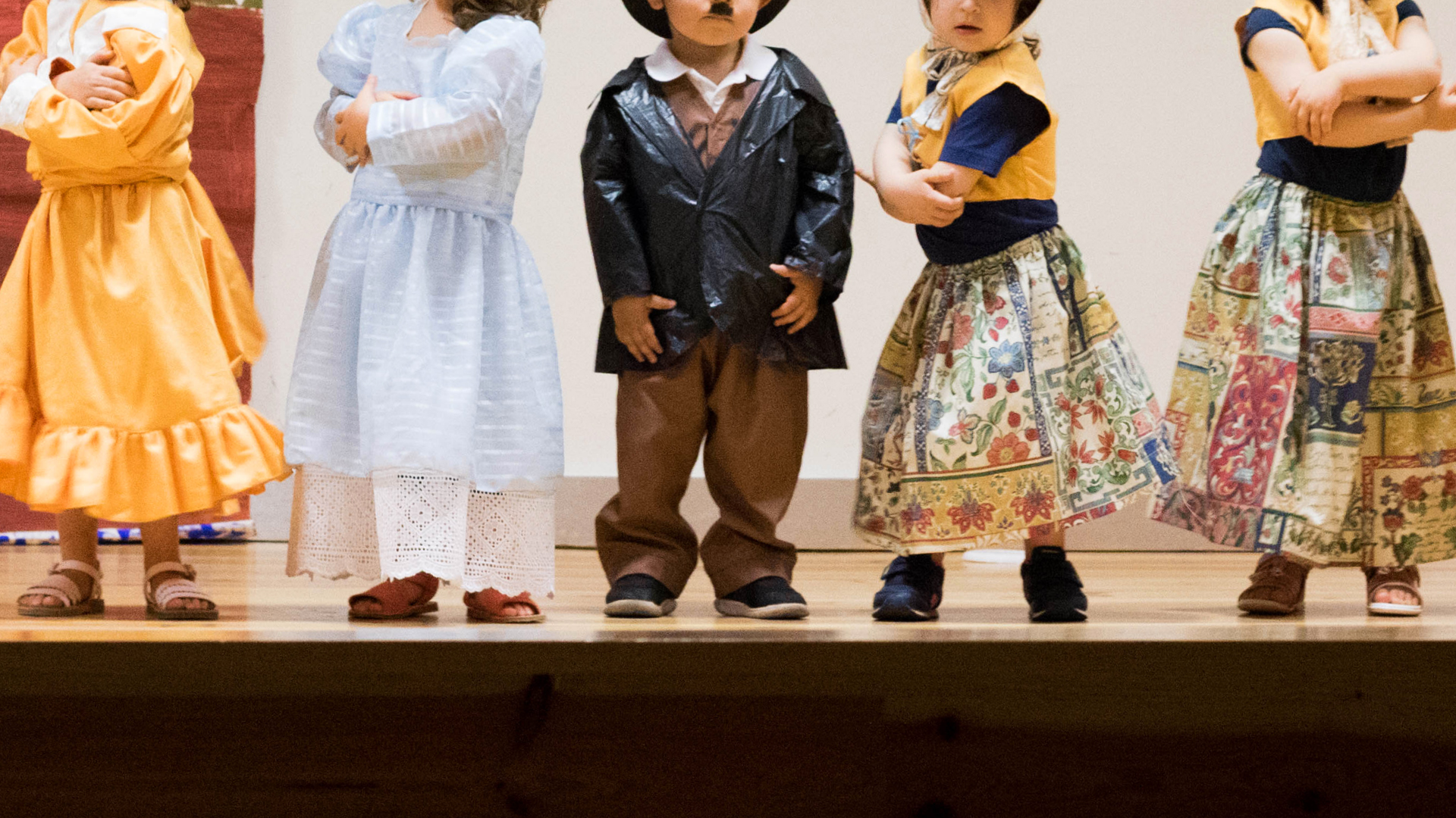 Preschool children in costumes performing on stage