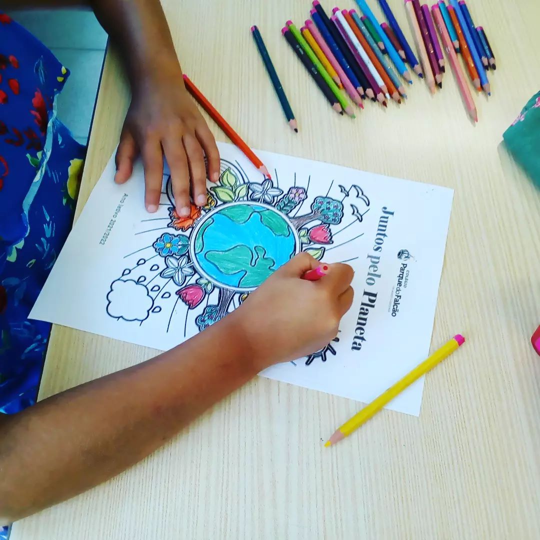 Preschool student coloring a drawing of the Earth