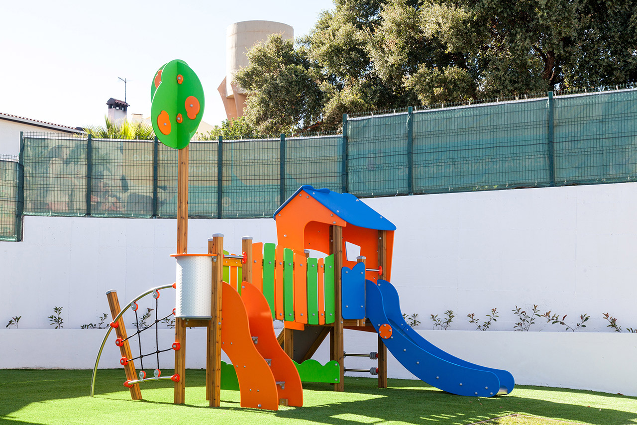 Colorful playground equipment at O Cantinho dos Amigos preschool
