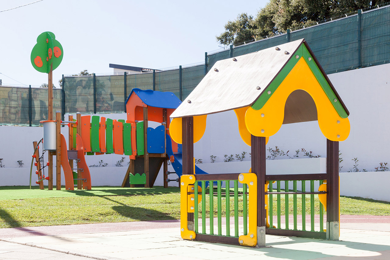 Colorful playground equipment at O Cantinho dos Amigos preschool
