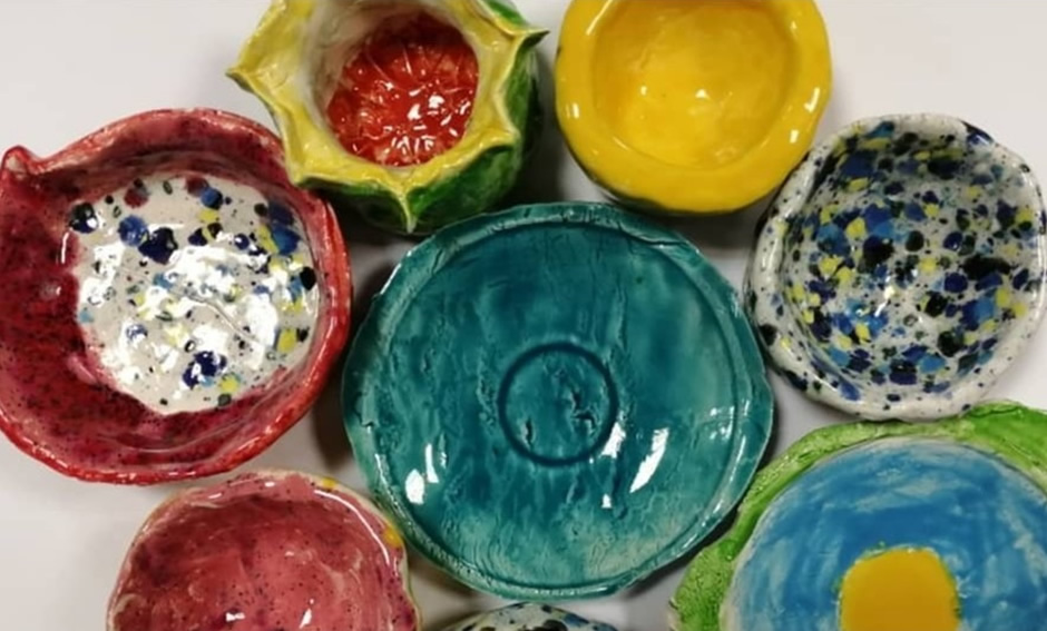 Colorful ceramic bowls and plates created by preschool students