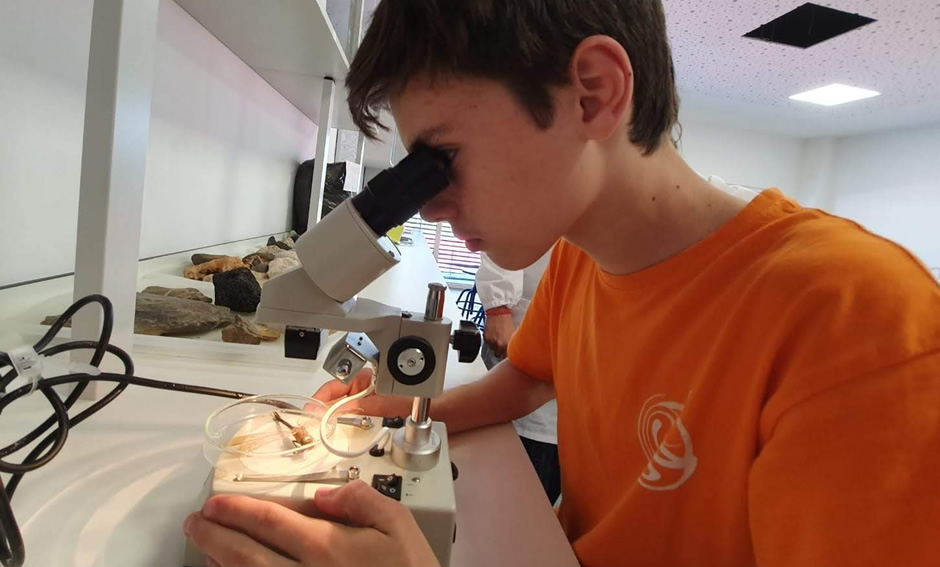 Student using a microscope in a science class