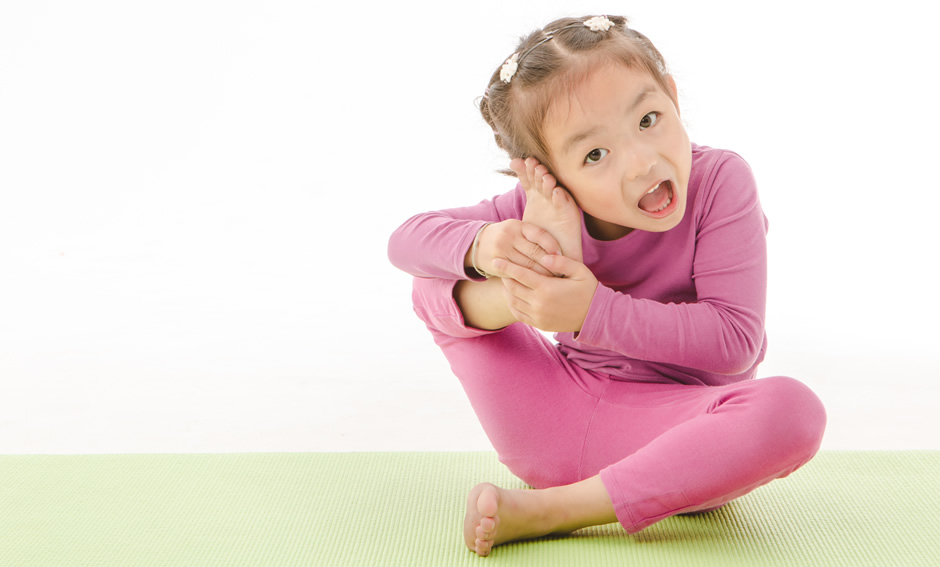 Preschool child doing yoga