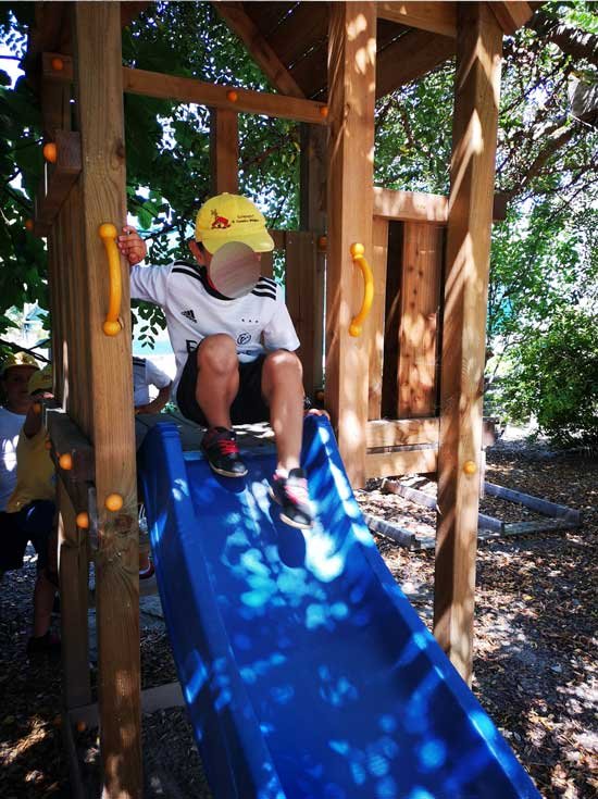 Preschool child going down a slide at A Casinha Mágica
