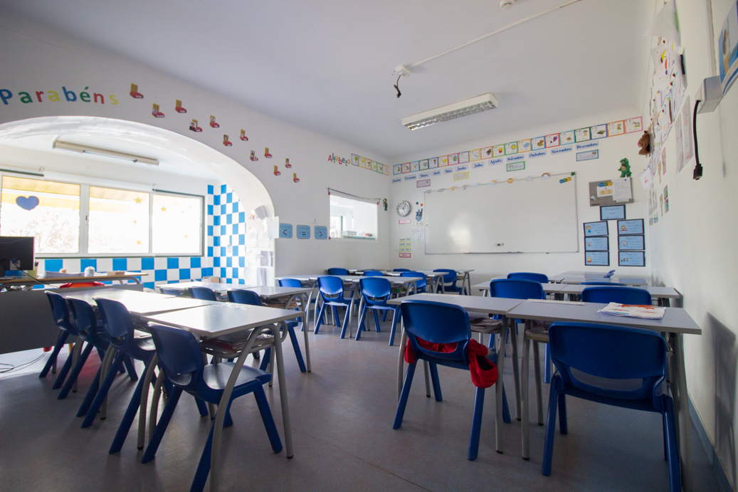 Preschool classroom with blue chairs and tables