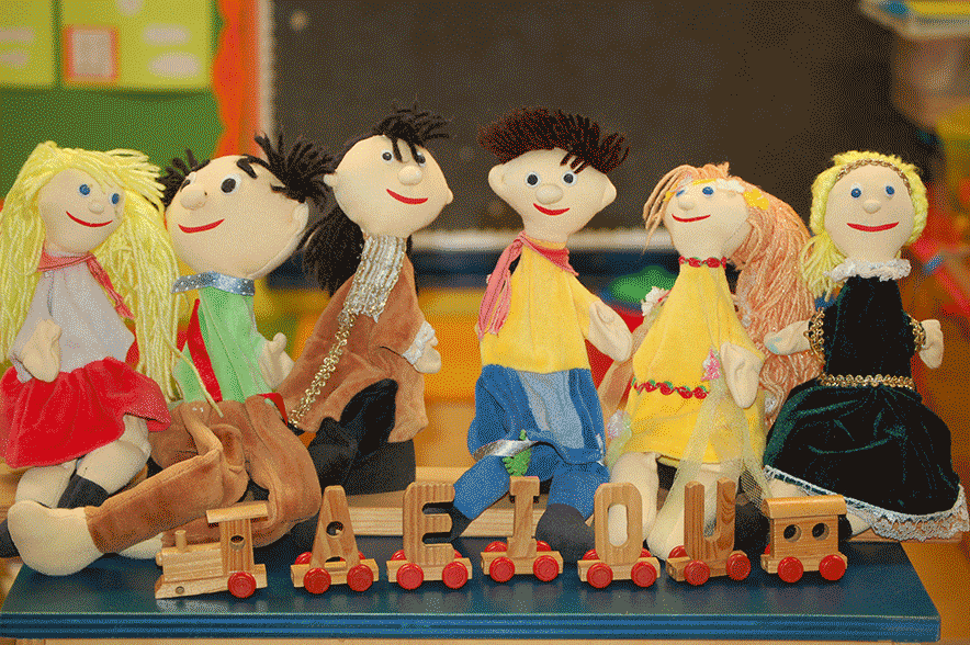 Wooden puppets and toy train with letters