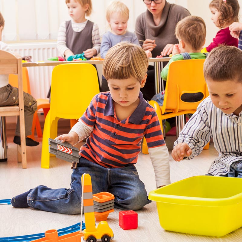 Preschool children playing with toys