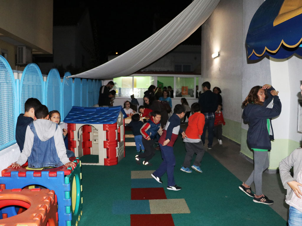 Preschool children playing in a playground at night