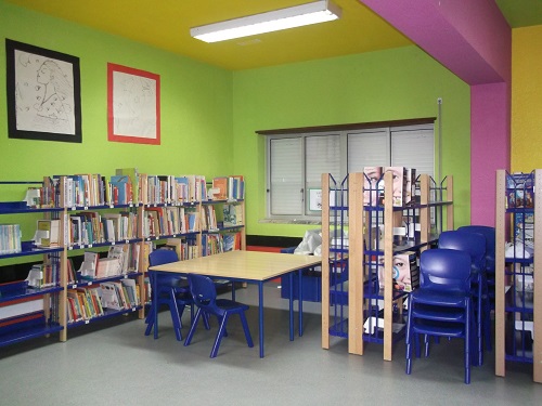 Preschool library with colorful walls and bookshelves filled with children's books