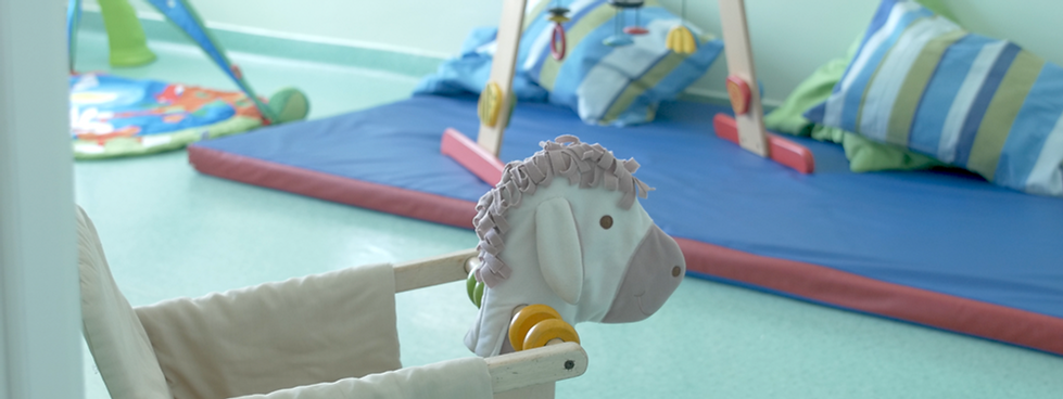 Preschool play area with rocking horse and play mat