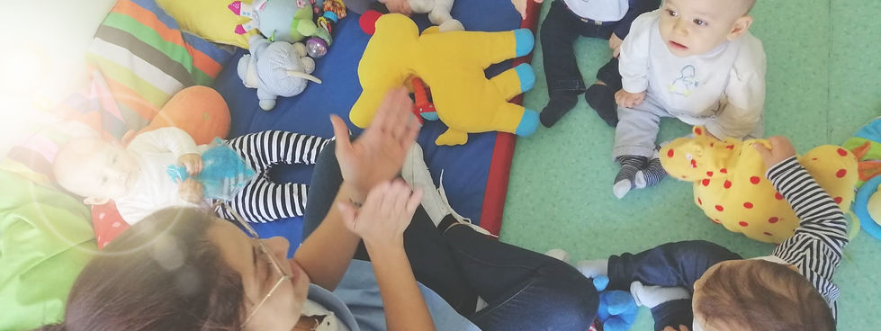 Preschool teacher interacting with toddlers during playtime
