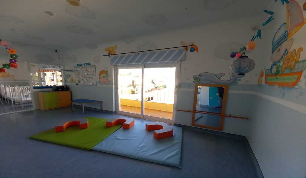 Preschool classroom with colorful decorations and play equipment