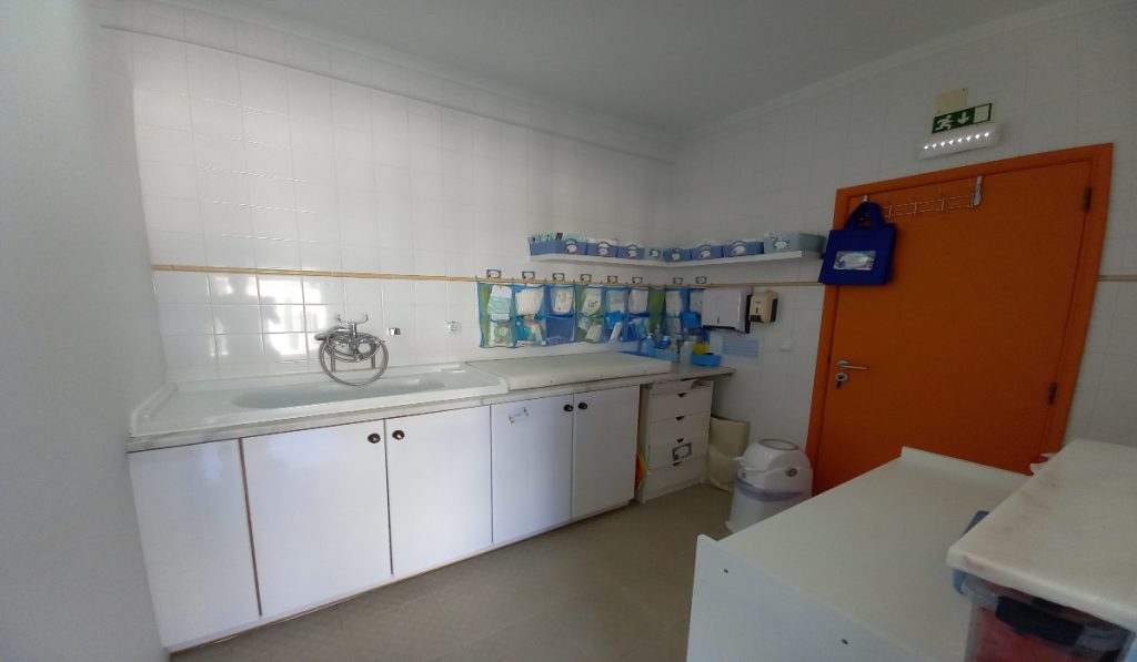 Preschool baby changing station with sink and cabinets