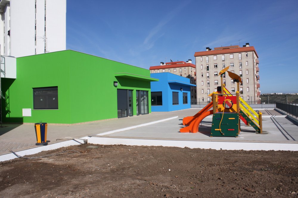 Colorful preschool playground with slides and climbing structures