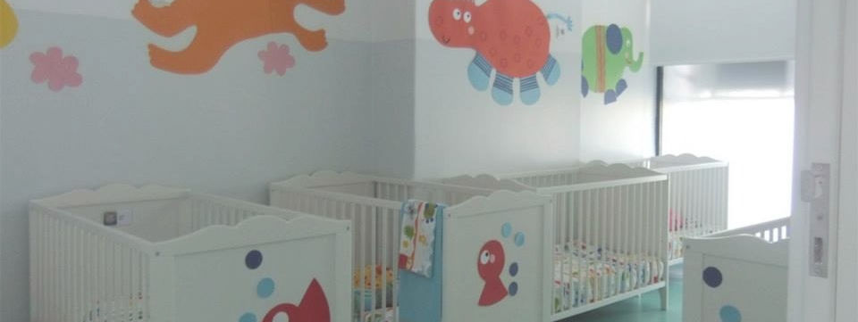 Preschool nursery with cribs and animal wall art