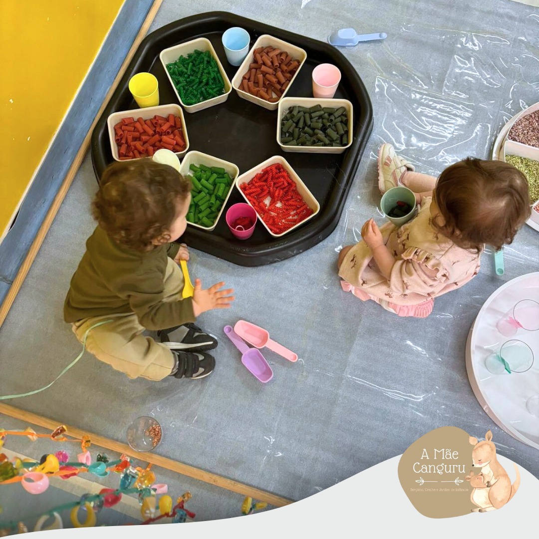 Preschool children engaged in a colorful sensory activity with pasta