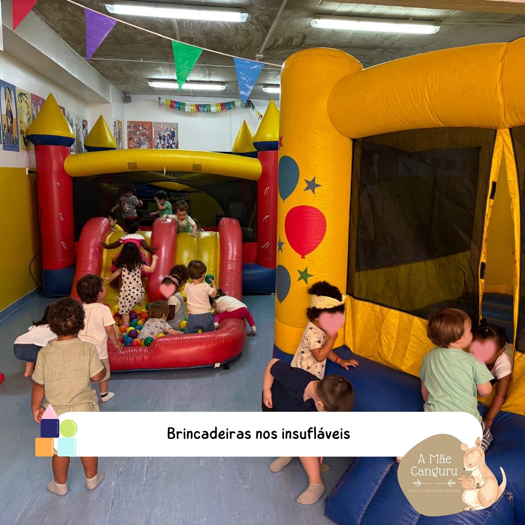 Preschool children playing in inflatable bounce houses