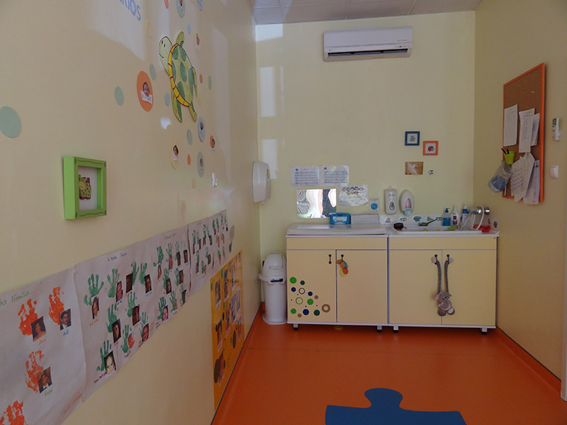 Preschool bathroom with colorful decorations and child-sized sink