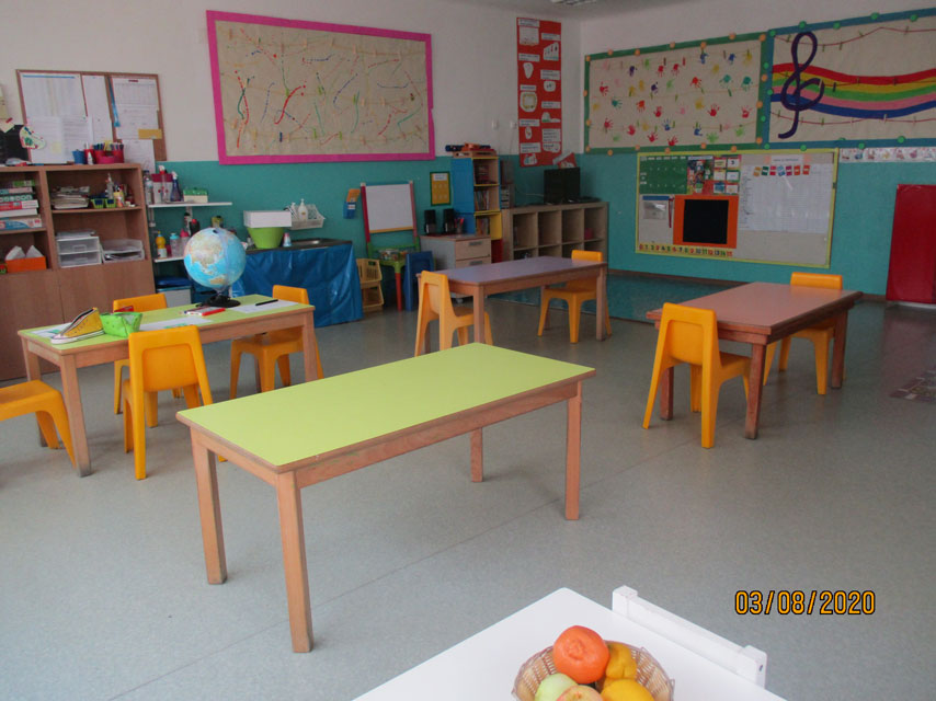 Preschool classroom with colorful tables and chairs