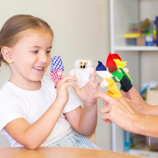 Preschool child playing with finger puppets