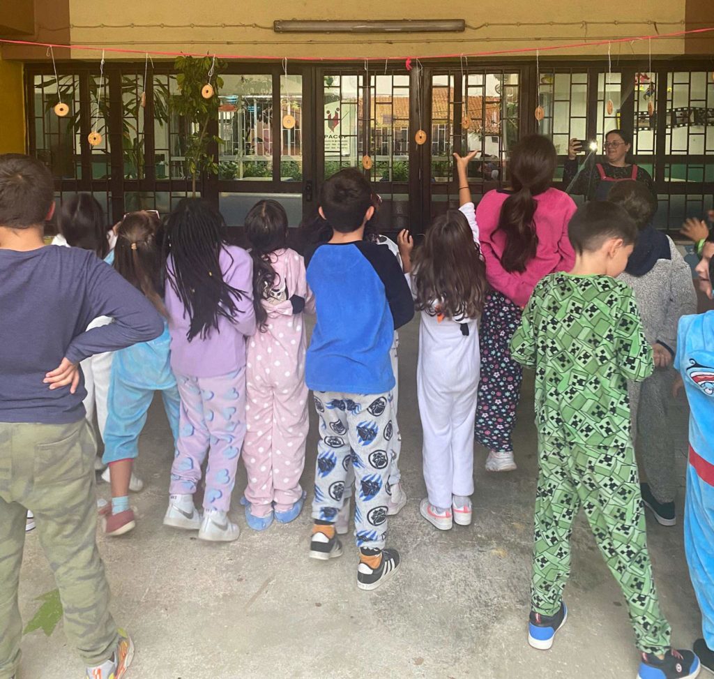Preschool children in pajamas participating in an activity