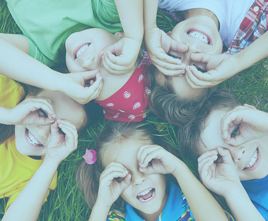 Happy preschool children playing in the grass