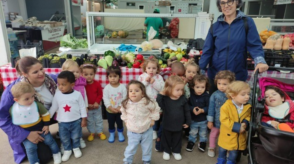 Preschool children on a field trip to a market, learning about healthy eating