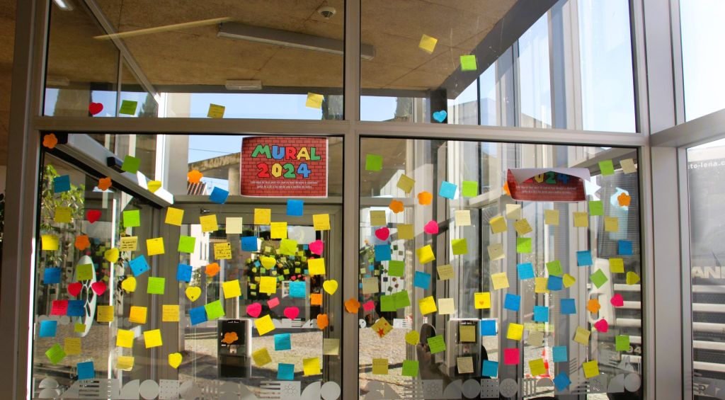 Colorful sticky notes on a glass wall, promoting a 2024 mural project.