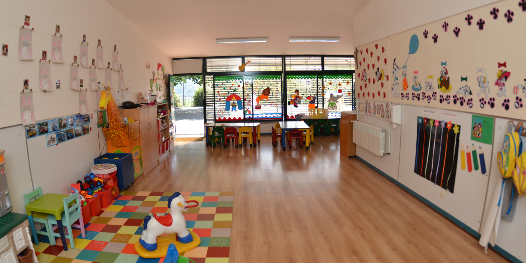 Preschool classroom with colorful decorations, toys, and furniture