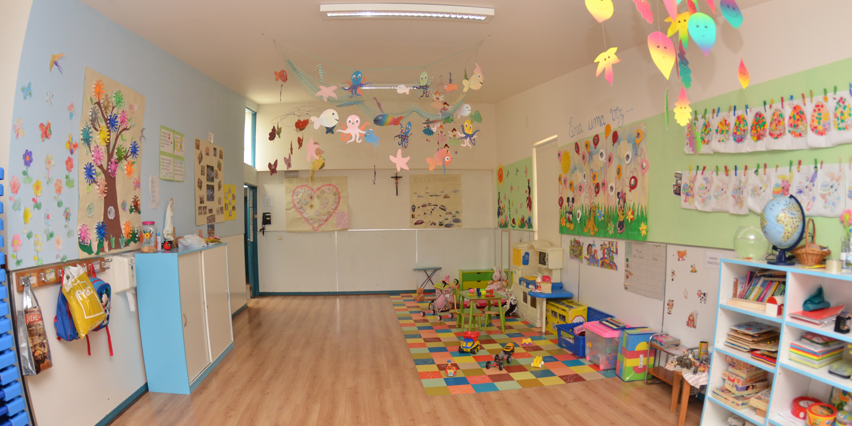 Preschool classroom with colorful decorations, toys, and learning materials