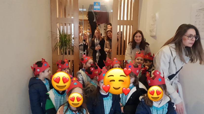 Preschool children in crowns celebrating a holiday or special event at Associação Maconde in Braga, Portugal