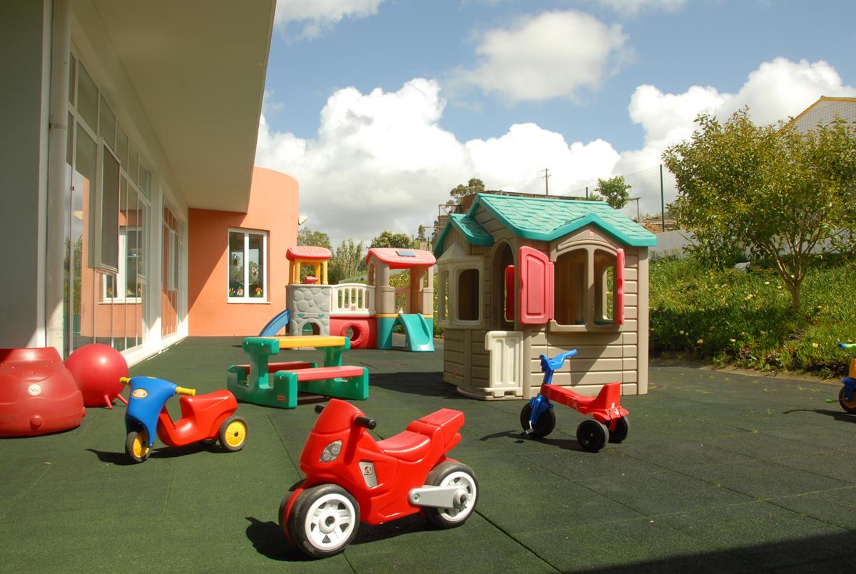 Preschool playground with colorful play structures and toys
