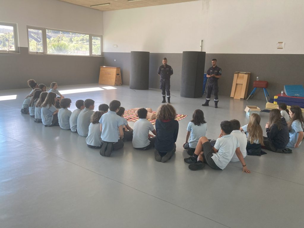Students at Colégio João Paulo II participating in a first aid or safety demonstration.