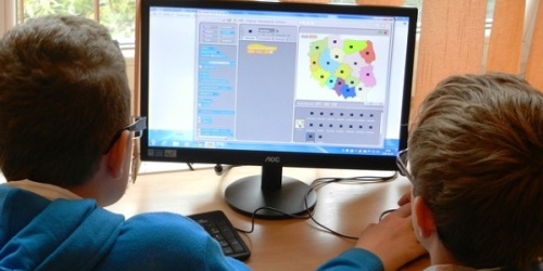Two students using a computer for educational purposes