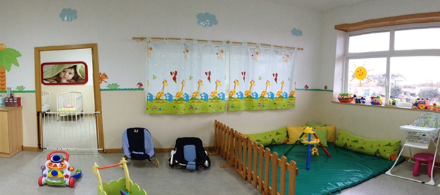 Preschool classroom with colorful decorations, toys, and play area