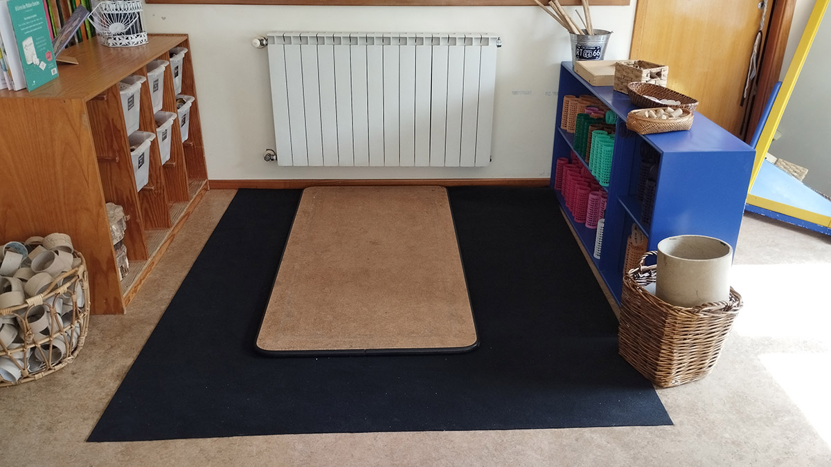 Preschool classroom with organized shelves and a balance beam