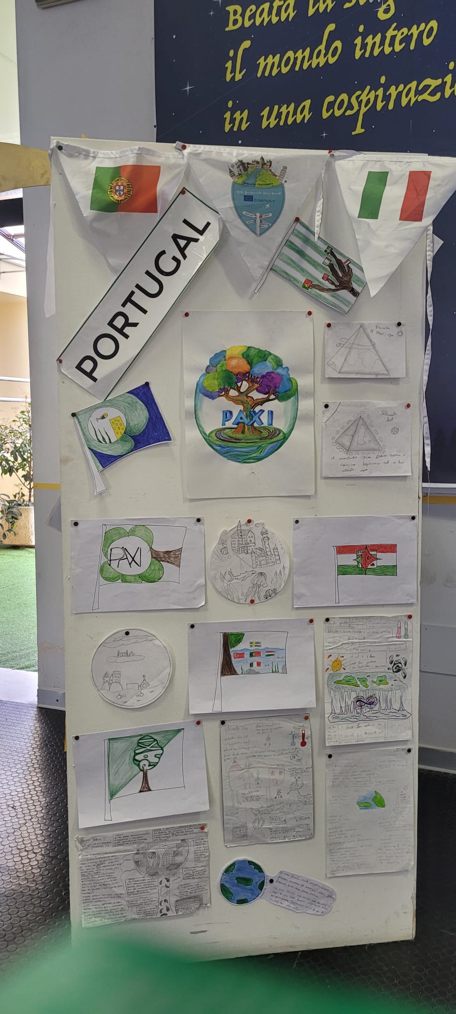Preschool children's artwork on display, showing flags and drawings related to Portugal and other countries.