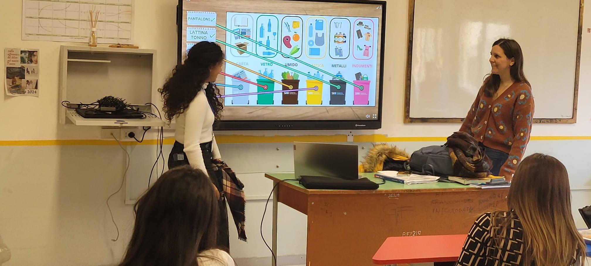 Preschool students attentively listen to a presentation about recycling and waste sorting, demonstrating environmental education in the classroom.