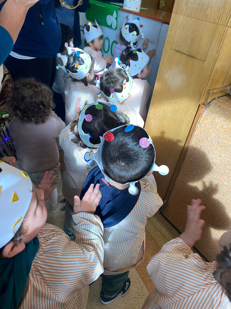 Preschool children wearing crowns participate in an activity
